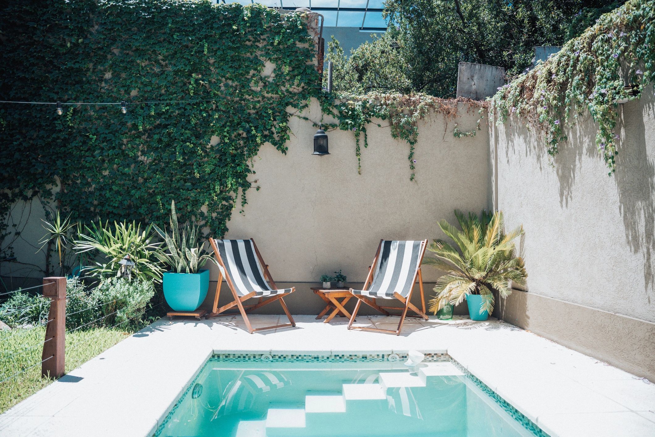 Outdoor patio seating area beside a pool